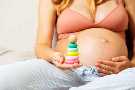Close-up of pyramid toy in pregnant woman bellyの写真素材