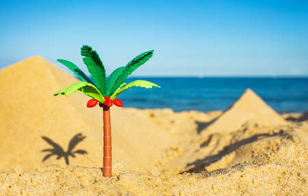 Miniature palm and two pyramids of sand close-upの写真素材