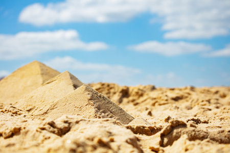 Miniature pyramids in desert made of sand on beachの写真素材