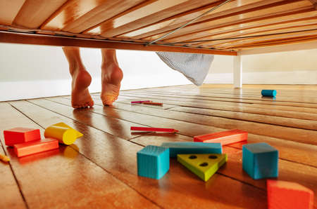 Feet of little boy wake up and stand from his bedの写真素材