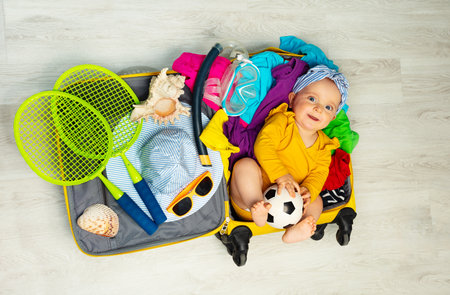 Little baby girl lay in the ready for travel suiteの写真素材