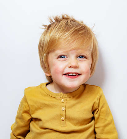 Close portrait smiling laughing little blond boyの写真素材