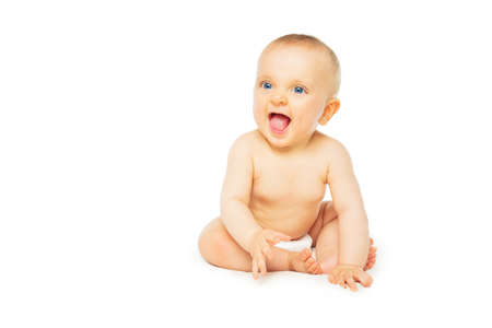 Baby girl in diaper isolated, sit smile and laughの写真素材
