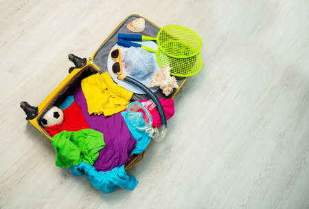 Open travel hand luggage suitcase ready for flightの写真素材