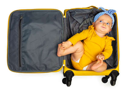 Little baby toddler girl in the empty travel caseの写真素材