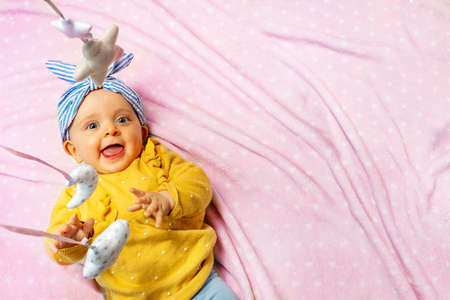 Baby girl laugh with mobile toys view from aboveの写真素材