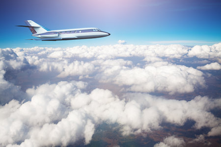 Business jet airplane fly above clouds in the skyの写真素材