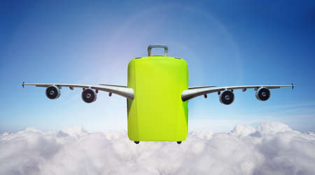 Suitcase with wings fly in clouds - travel conceptの写真素材