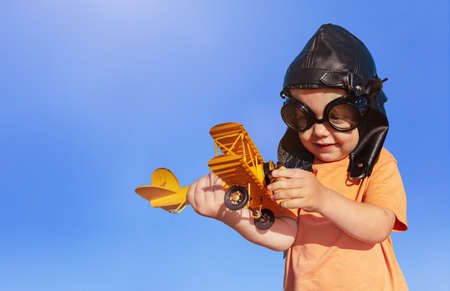 Little toddler boy play with aviation plane modelの写真素材