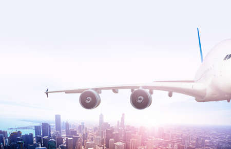 Wing of big jet airplane fly over Chicago downtownの写真素材