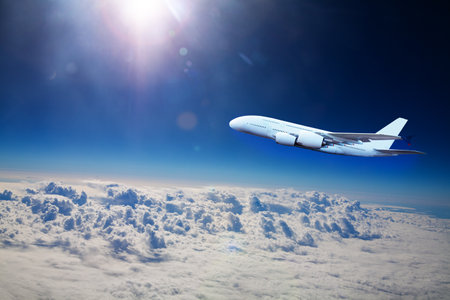 Big jet plane fly above clouds at high altitudeの写真素材