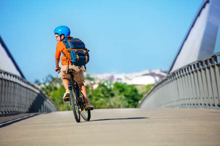 Portrait of a child ride on bicycle back rear viewの写真素材