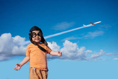 Travel concept boy over sky with commercial planeの写真素材