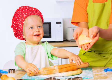 Smiling happy boy roll rolling-pin prepare doughの写真素材