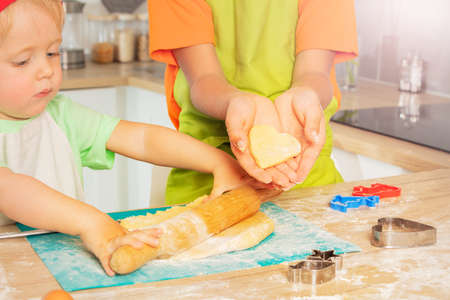 Little toddler boy roll rolling-pin prepare doughの写真素材