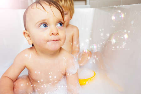 Little baby girl having fun time in the bathroomの写真素材