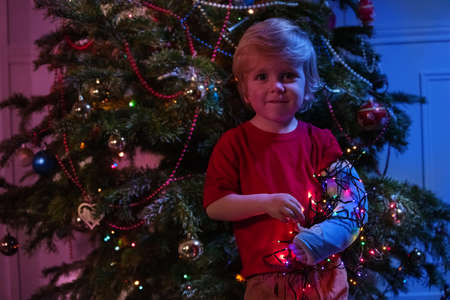 Childs broken hand in a cast and Christmas lightsの写真素材