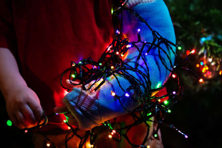 Portrait of toddlers broken hand by Christmas treeの写真素材