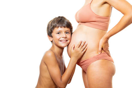 Child hands touch pregnant belly: expect a sisterの写真素材