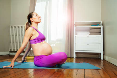 Pregnant young mother exercise prepare for birthの写真素材