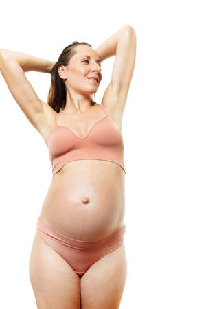 Happy relaxed pregnant woman in body color underwearの写真素材