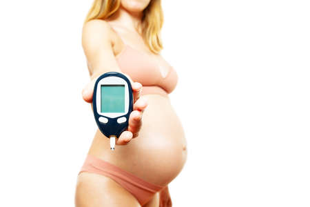 Pregnant woman show diabetes tester devide losupの写真素材