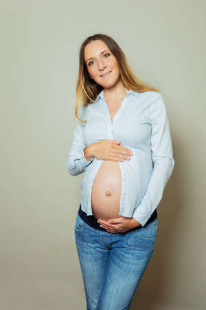 Pregnant working woman wear formal shirt showing big bellyの写真素材