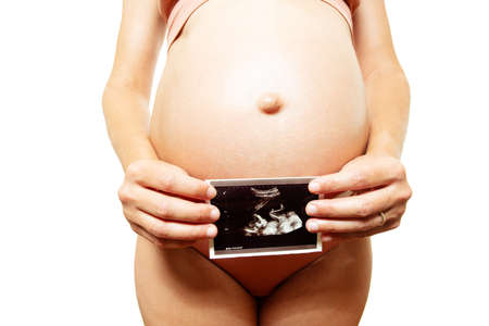 Close-up of a pregnant woman hold ultrasound imageの写真素材