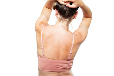 Back view of the woman shoulders holding hair, over whiteの写真素材