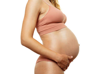 Close-up in profile of a pregnant womans bellyの写真素材