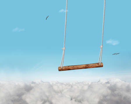 Swing bar swinging over blue sky with clouds foamの写真素材
