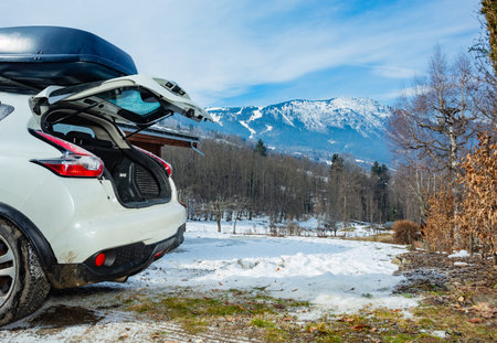 Open trunk of the car arrived at winter vacation destinationの写真素材