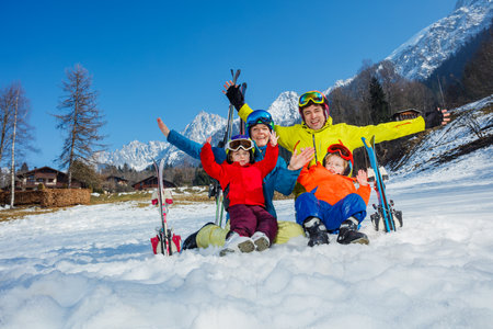 Happy ski vacation with kids dad and children cheer lift handsの写真素材