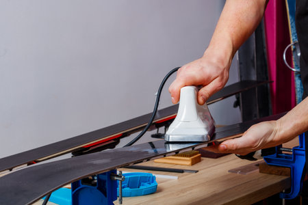 Melting wax in workshop to coat ski base for improved glideの写真素材