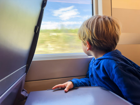 Little boy sit and looking at the window inside high speedの写真素材
