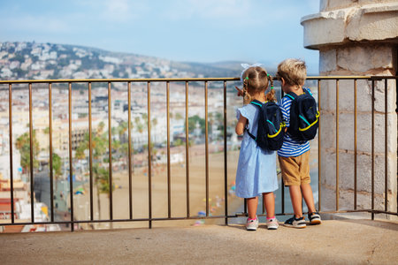 Young cute tourists boy and girl enjoy Spanish seaside viewsの写真素材