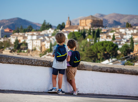 Adventurous little kids overlook panorama of Ronda, Spainの写真素材