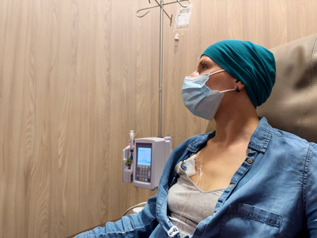 Woman with headscarf have IV chemotherapy treatment in hospitalの写真素材