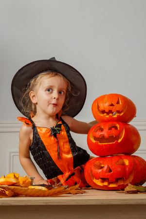 Child dressed as witch celebrates Halloween make funny facesの写真素材