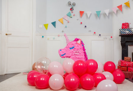 Bright party decor featuring a cheerful and pink unicorn pinataの写真素材