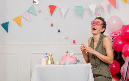 Woman celebrate 39th birthday party with festive decor and joyの写真素材