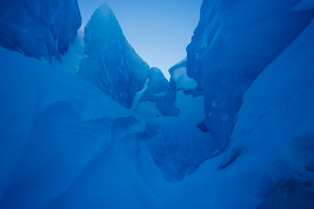 Icy passageway through dramatic intouched blue glacier peaksの写真素材