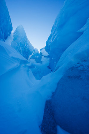 Majestic icy blue corridor amidst towering glaciers in Arcticの写真素材