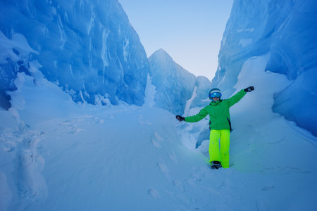 Vibrant ski gear contrasts against a breathtaking icy backdropの写真素材