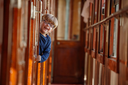 Little kid having fun playing hide and seek in old train carの写真素材