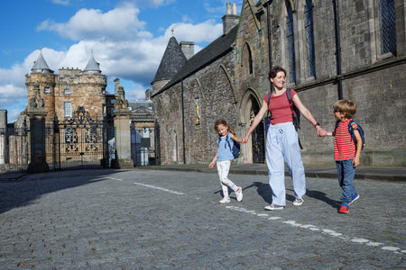 Family with kids explores historic part of Edinburgh downtownの写真素材