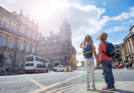 Young adventurers bask in sunlight, exploring Edinburgh downtownの写真素材