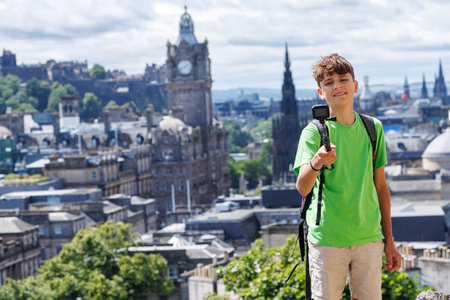 Boy in green enjoy a sunny day, capture city view on Calton Hillの写真素材