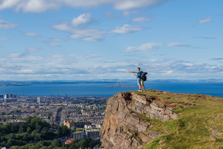 Exploring hikers point horizon on top of Arthurs Seat, Edinburgの写真素材