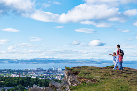 Happy hiker family on top of Arthurs Seat mountain, Edinburghの写真素材